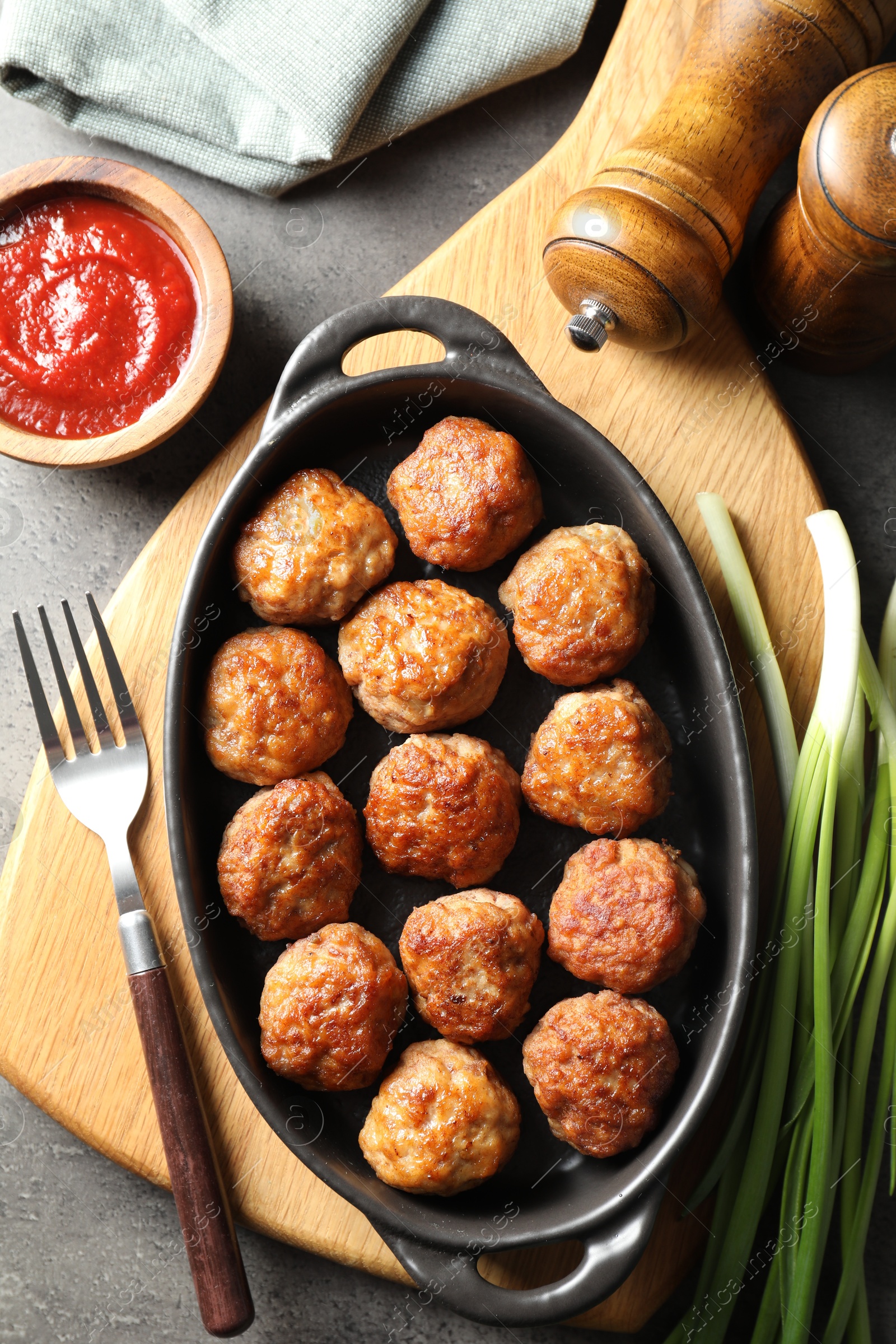 Photo of Tasty meatballs served on grey table, flat lay