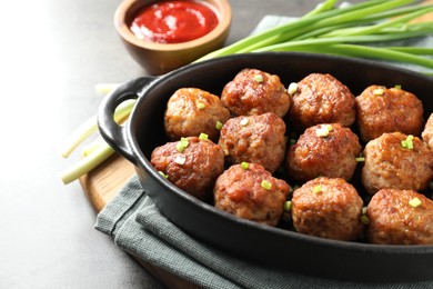 Photo of Tasty meatballs served on grey table, closeup