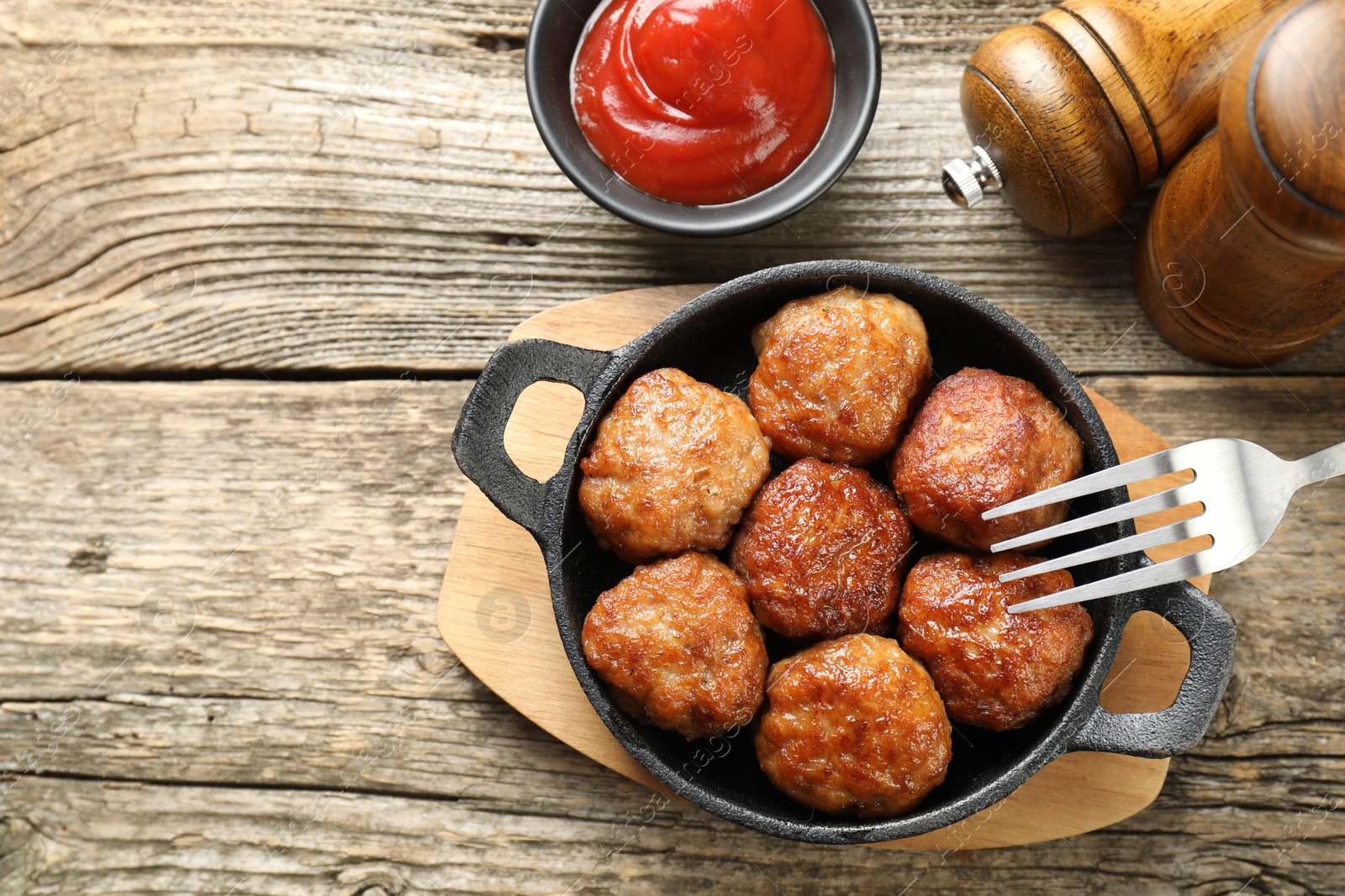 Photo of Tasty meatballs in baking dish served on wooden table, flat lay. Space for text