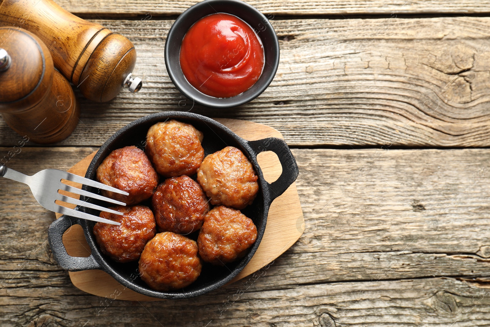 Photo of Tasty meatballs in baking dish served on wooden table, flat lay. Space for text