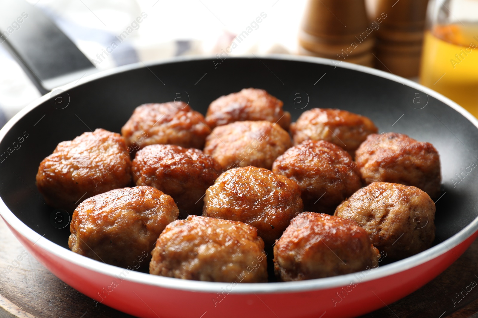 Photo of Tasty meatballs in frying pan on table, closeup