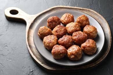 Photo of Tasty cooked meatballs on grey table, closeup