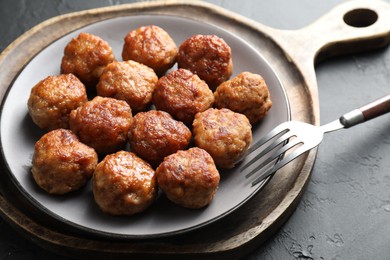 Photo of Tasty cooked meatballs served on grey table, closeup