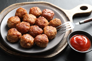 Photo of Tasty cooked meatballs served on grey table