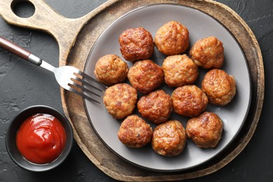 Photo of Tasty meatballs served on grey table, flat lay