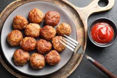 Photo of Tasty meatballs served on grey table, flat lay