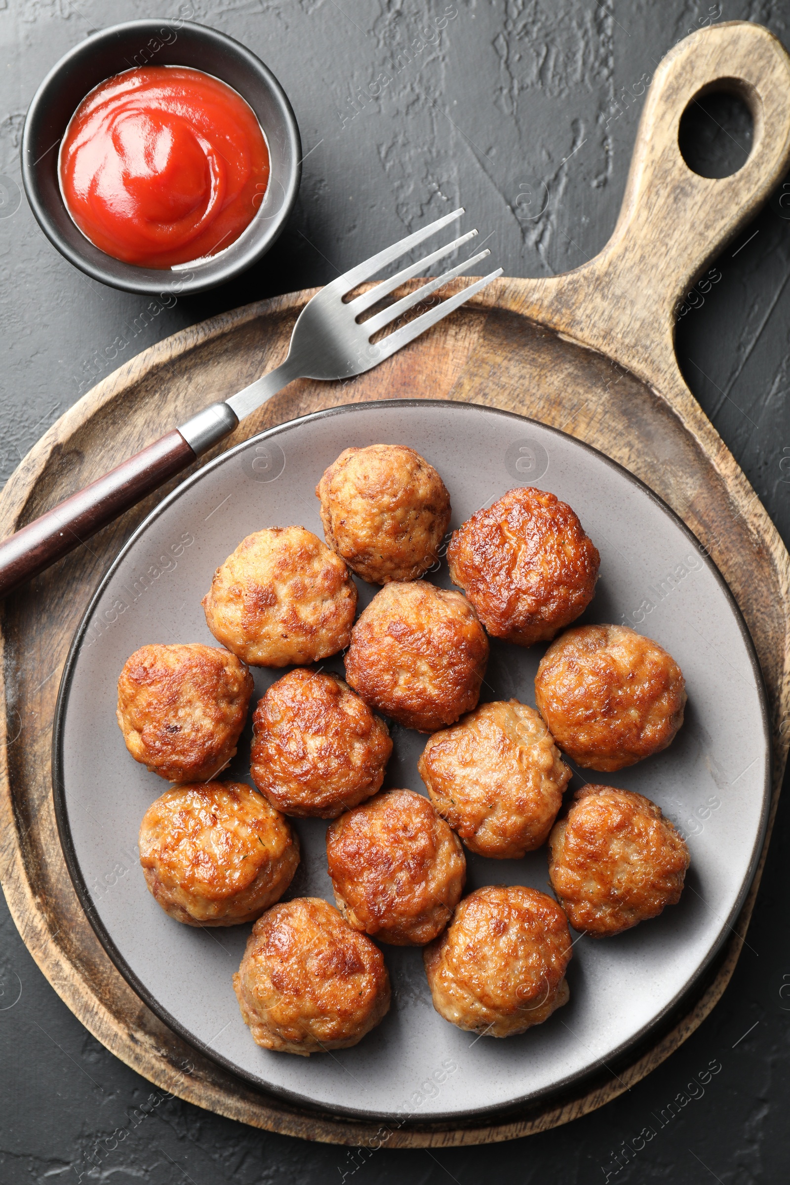 Photo of Tasty meatballs served on grey table, flat lay