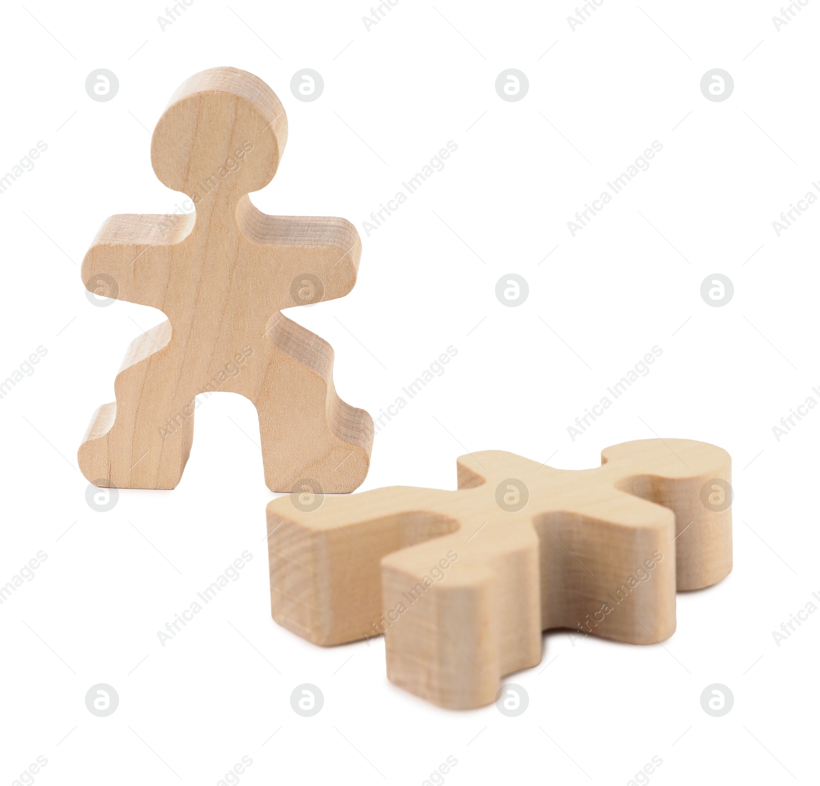 Photo of Wooden human figure near fallen one on white background. Competition concept