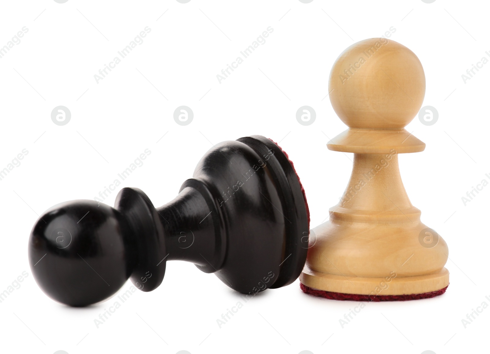 Photo of White pawn near fallen black one on white background. Competition concept