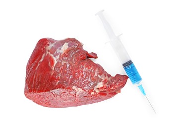 Photo of GMO concept. Piece of meat and syringe isolated on white, top view