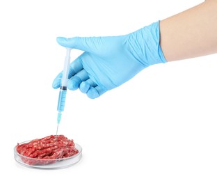 GMO concept. Scientist injecting something into minced meat on white background, closeup