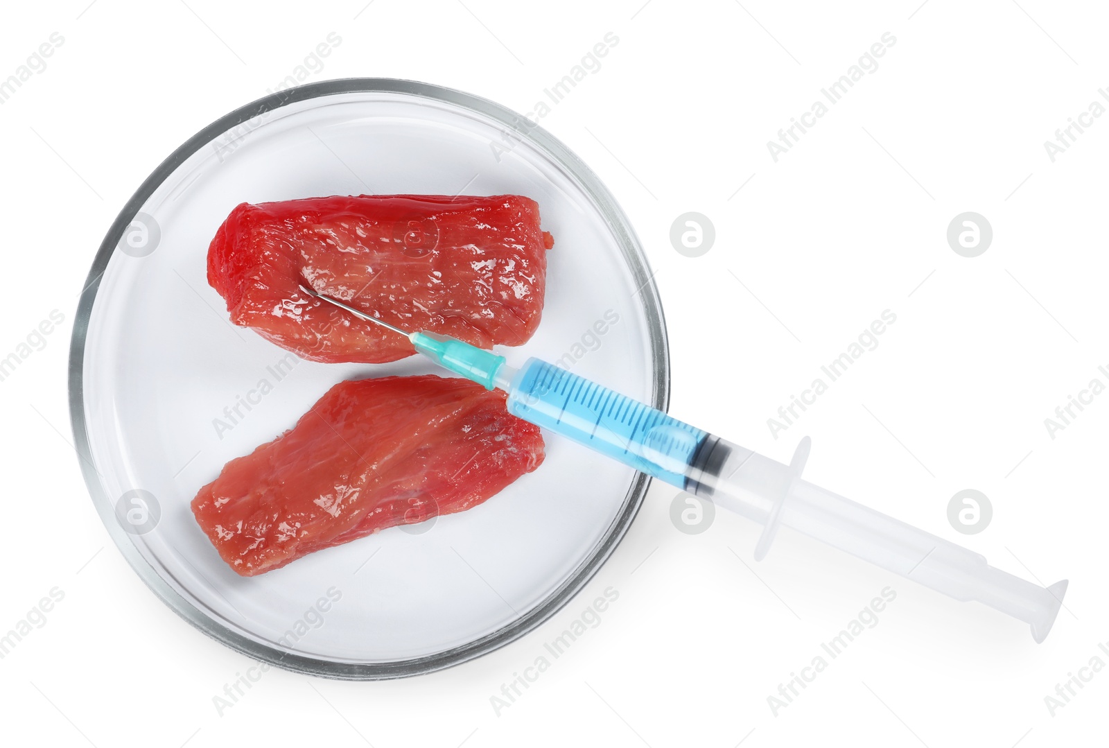 Photo of GMO concept. Pieces of meat and syringe isolated on white, top view