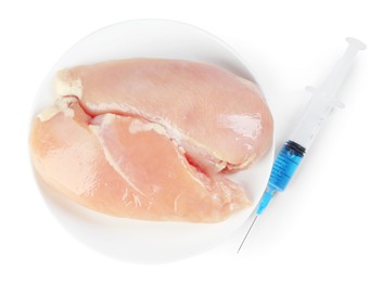 GMO concept. Chicken breasts and syringe isolated on white, top view