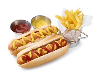 Photo of Tasty hot dogs with fries and sauces isolated on white