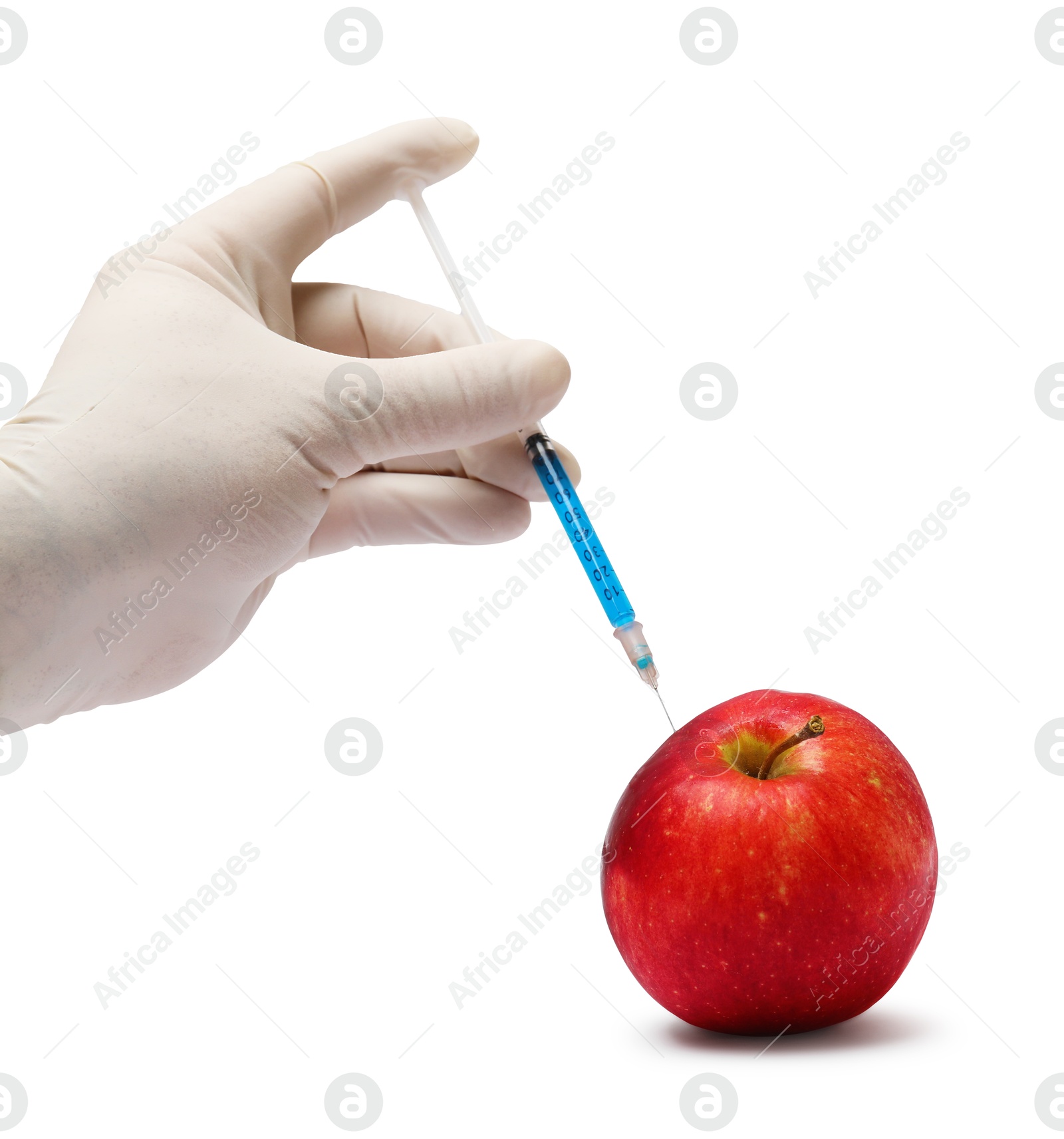 Photo of GMO concept. Scientist injecting something into fresh apple against white background, closeup