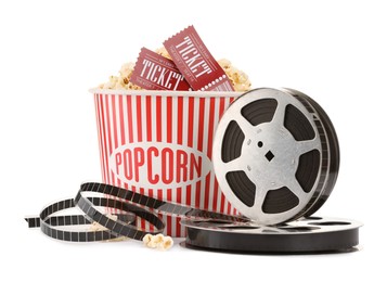 Photo of Tasty popcorn, film reels and movie tickets isolated on white