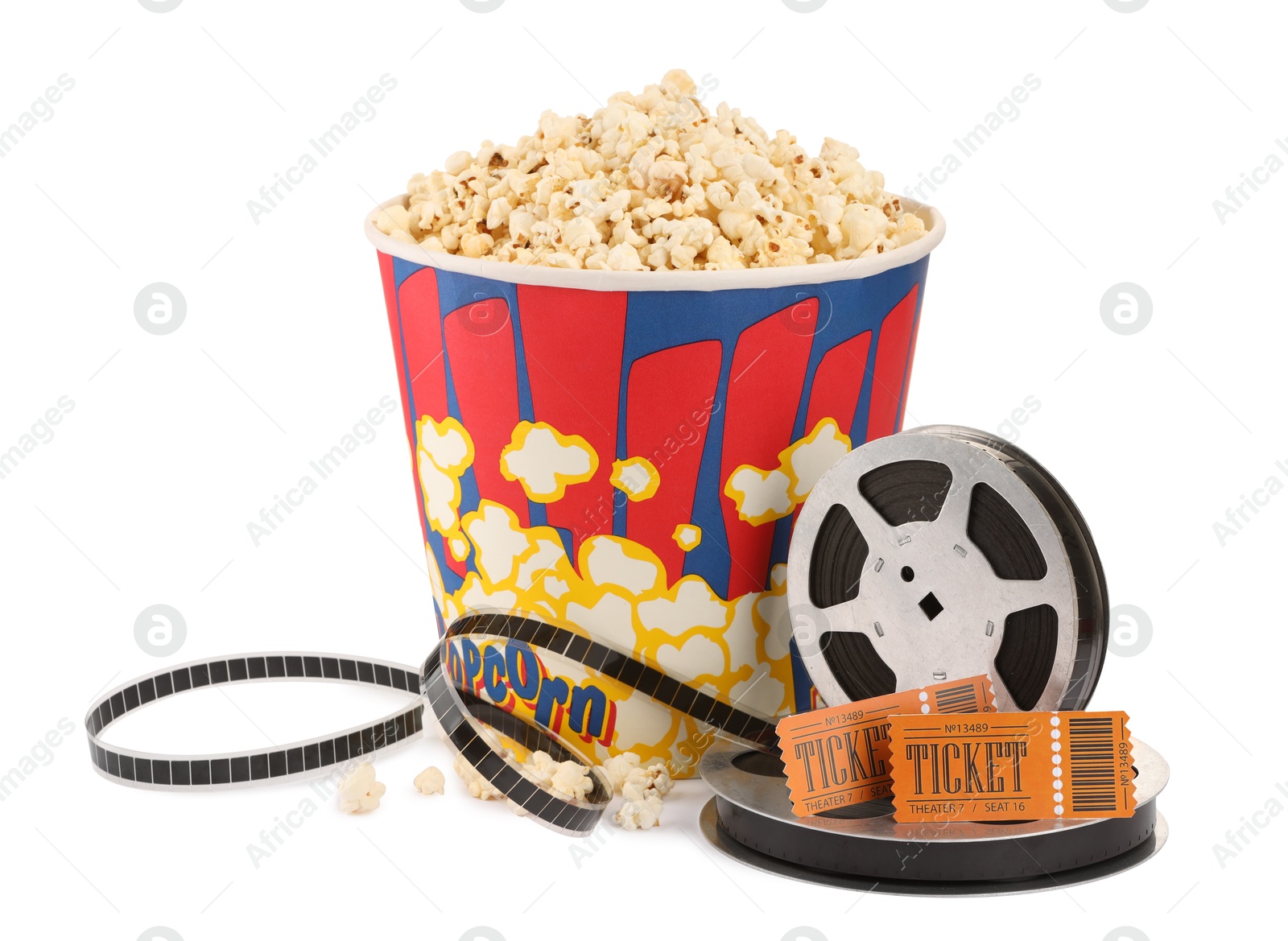 Photo of Tasty popcorn, film reels and movie tickets isolated on white