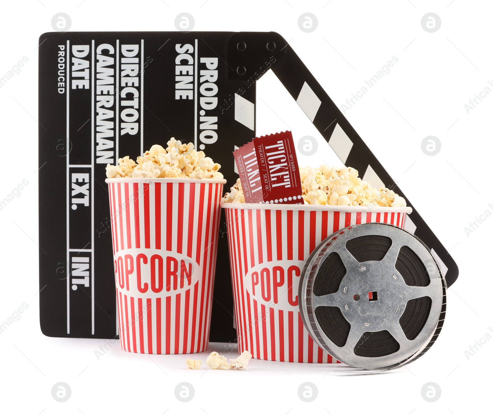 Photo of Tasty popcorn, film reel, clapper and movie tickets isolated on white