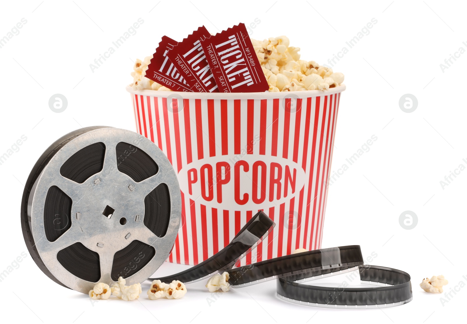 Photo of Tasty popcorn, film reel and movie tickets isolated on white