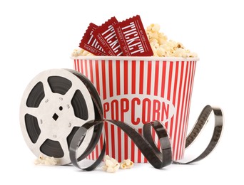 Photo of Tasty popcorn, film reel and movie tickets isolated on white