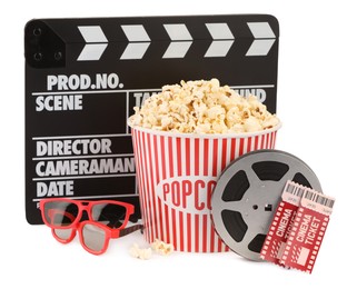 Photo of Tasty popcorn, film reel, clapper, glasses and movie tickets isolated on white