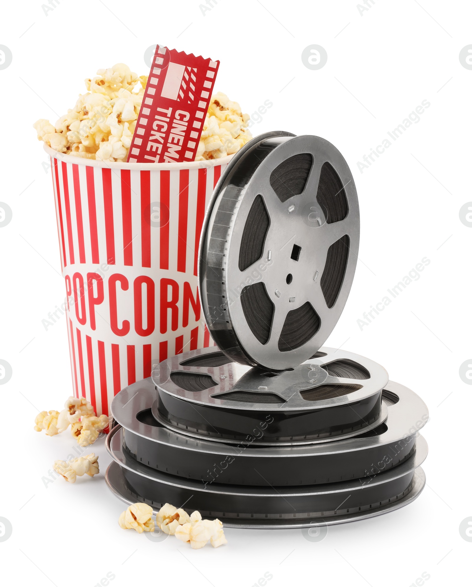 Photo of Tasty popcorn, film reels and movie ticket isolated on white