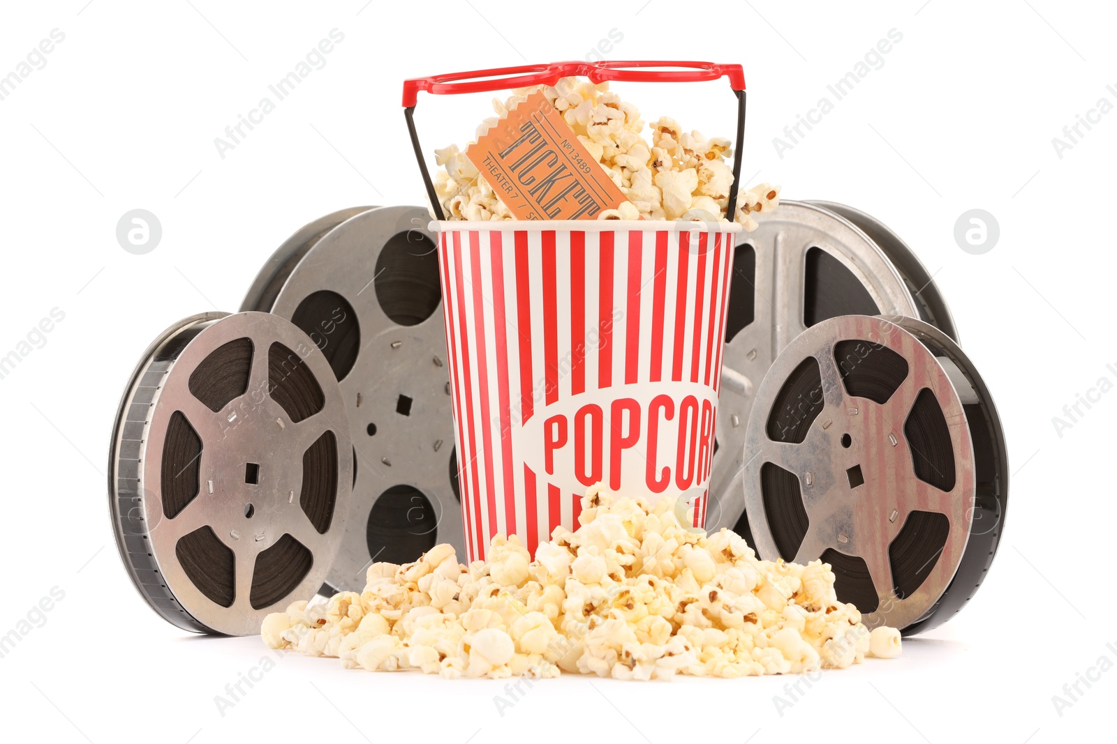 Photo of Tasty popcorn, film reels, glasses and movie ticket isolated on white