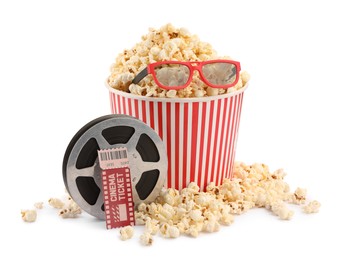 Photo of Tasty popcorn, film reel, glasses and movie ticket isolated on white