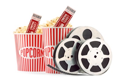 Photo of Tasty popcorn, film reels and movie tickets isolated on white