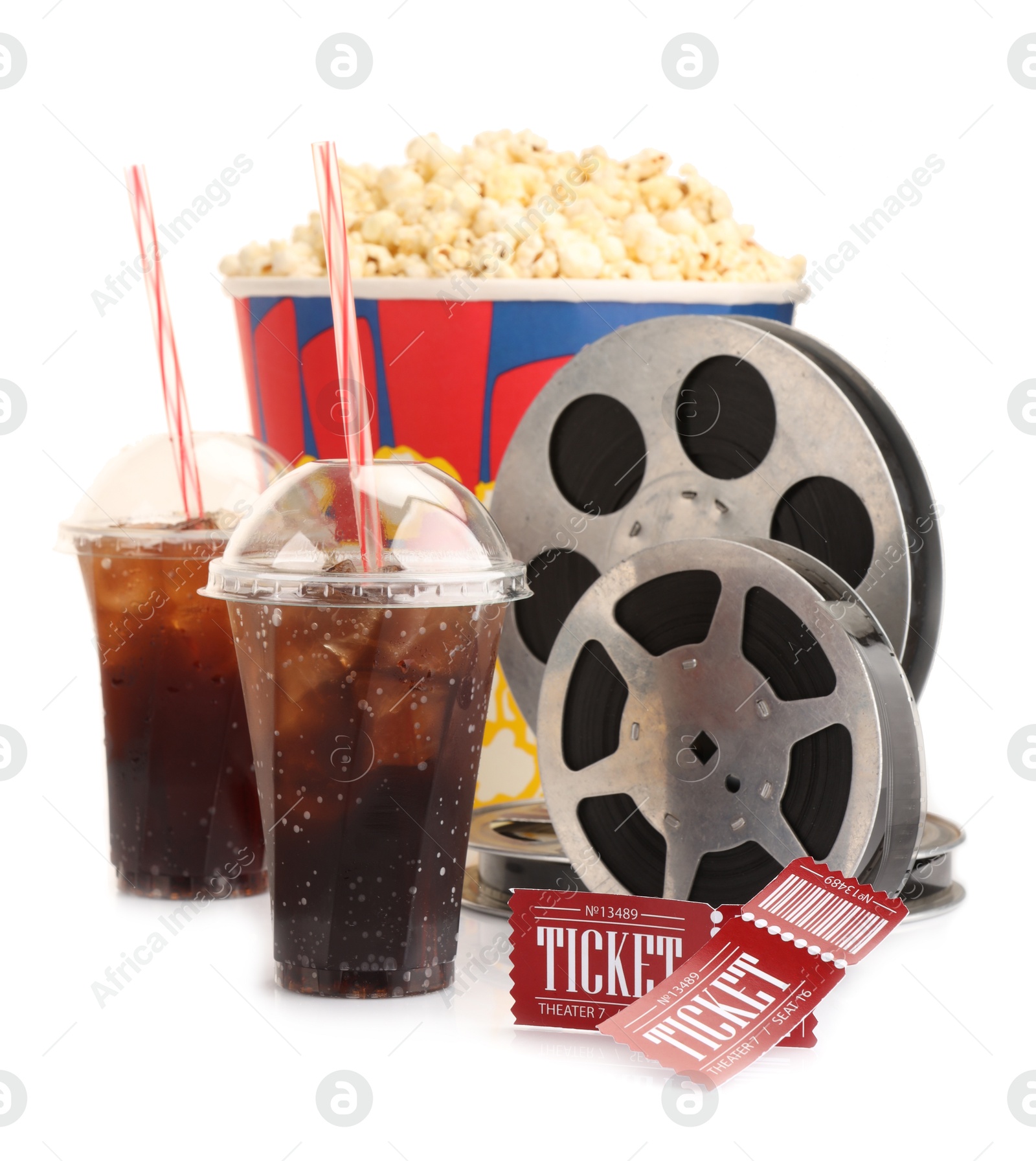 Photo of Tasty popcorn, film reels, soda drinks and movie tickets isolated on white