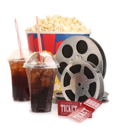 Photo of Tasty popcorn, film reels, soda drinks and movie tickets isolated on white