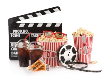 Photo of Tasty popcorn, film reel, glasses, clapper, soda drinks and movie tickets isolated on white