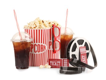 Photo of Tasty popcorn, glasses, film reel, soda drinks and movie tickets isolated on white