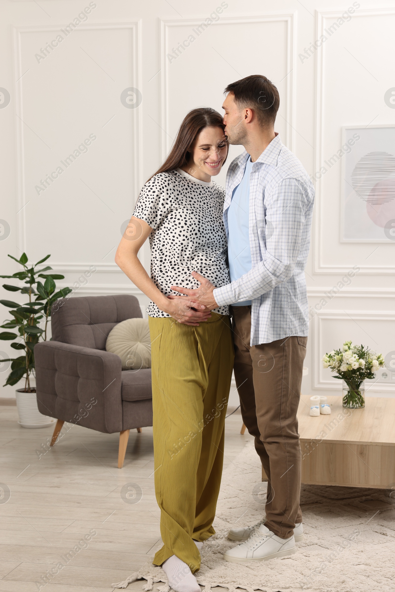 Photo of Pregnant woman and her husband at home