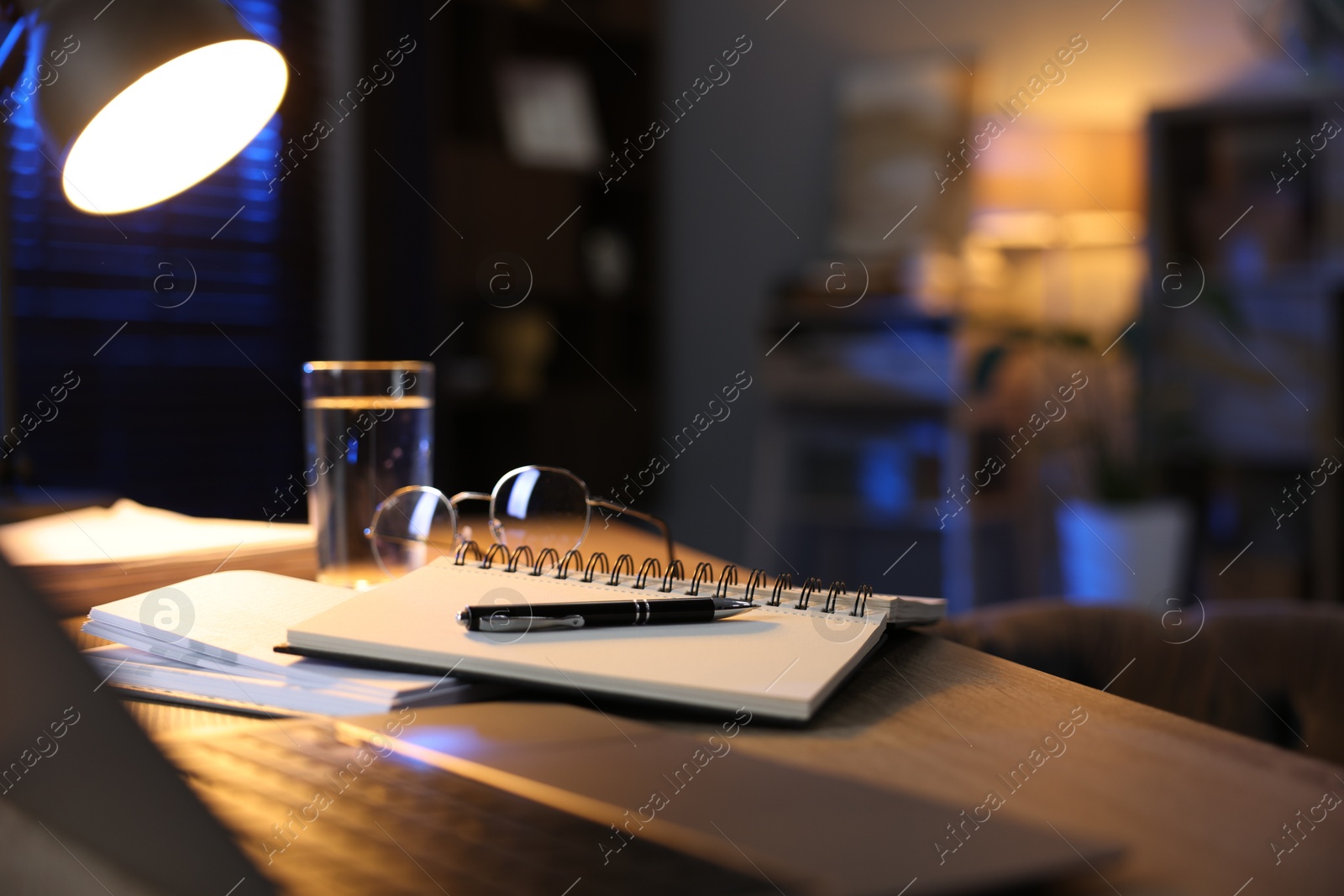 Photo of Workspace with laptop on wooden desk in home office, selective focus. Space for text