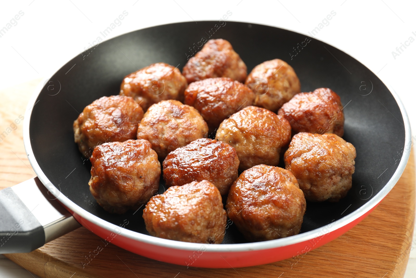 Photo of Tasty meatballs in frying pan on white table, closeup