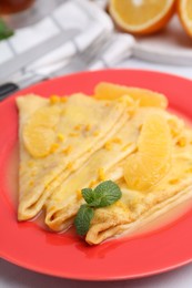 Photo of Plate with tasty crepes Suzette on white table, closeup