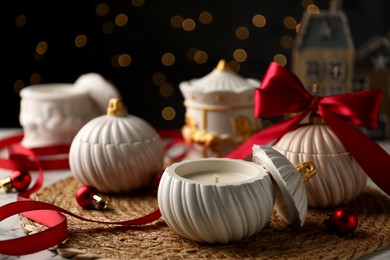 Photo of Soy wax candles on table, closeup. Beautiful Christmas decor