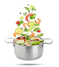 Image of Vegetables and shrimps for soup and pot in air on white background