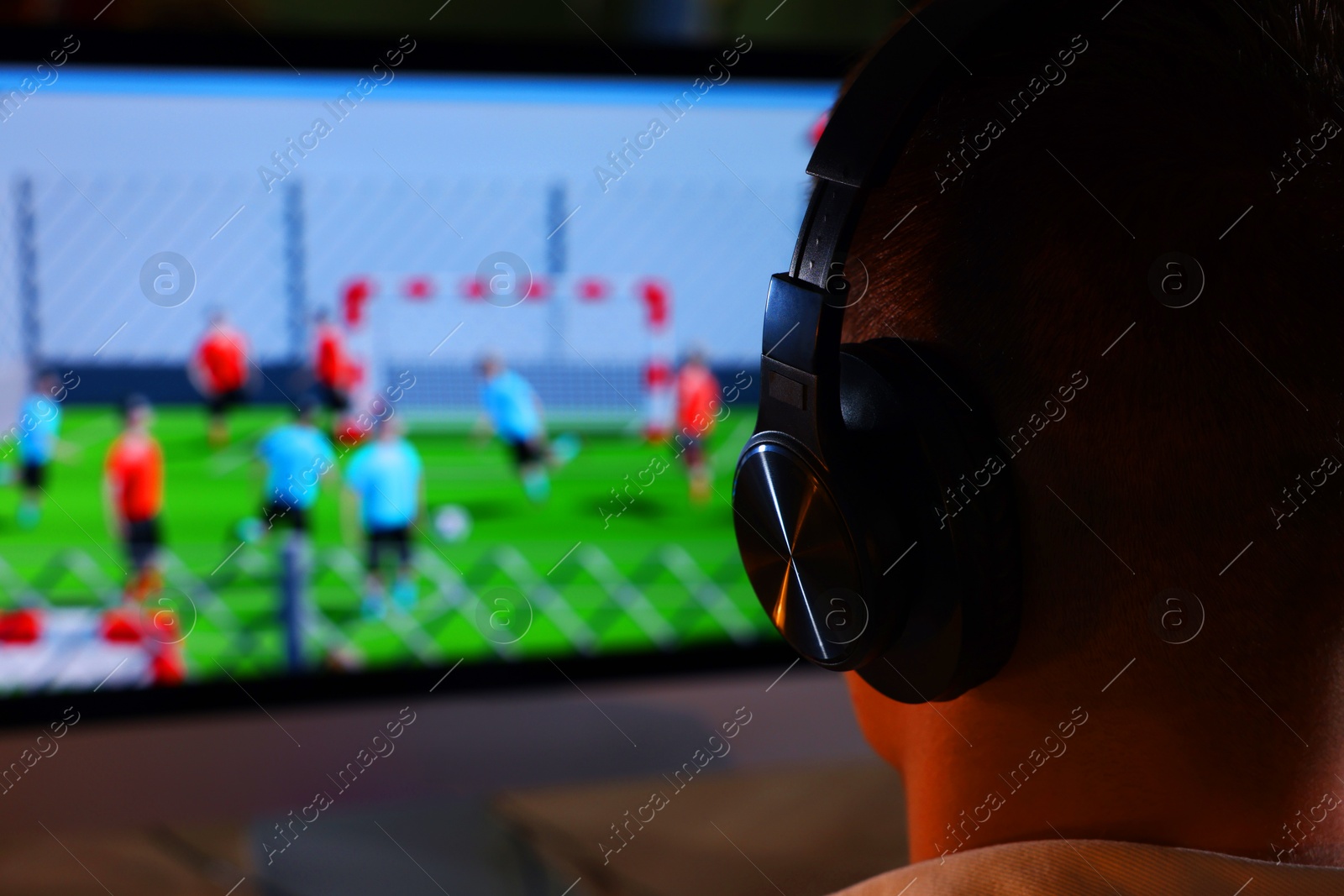 Photo of Young man playing video game at table indoors, closeup. Space for text