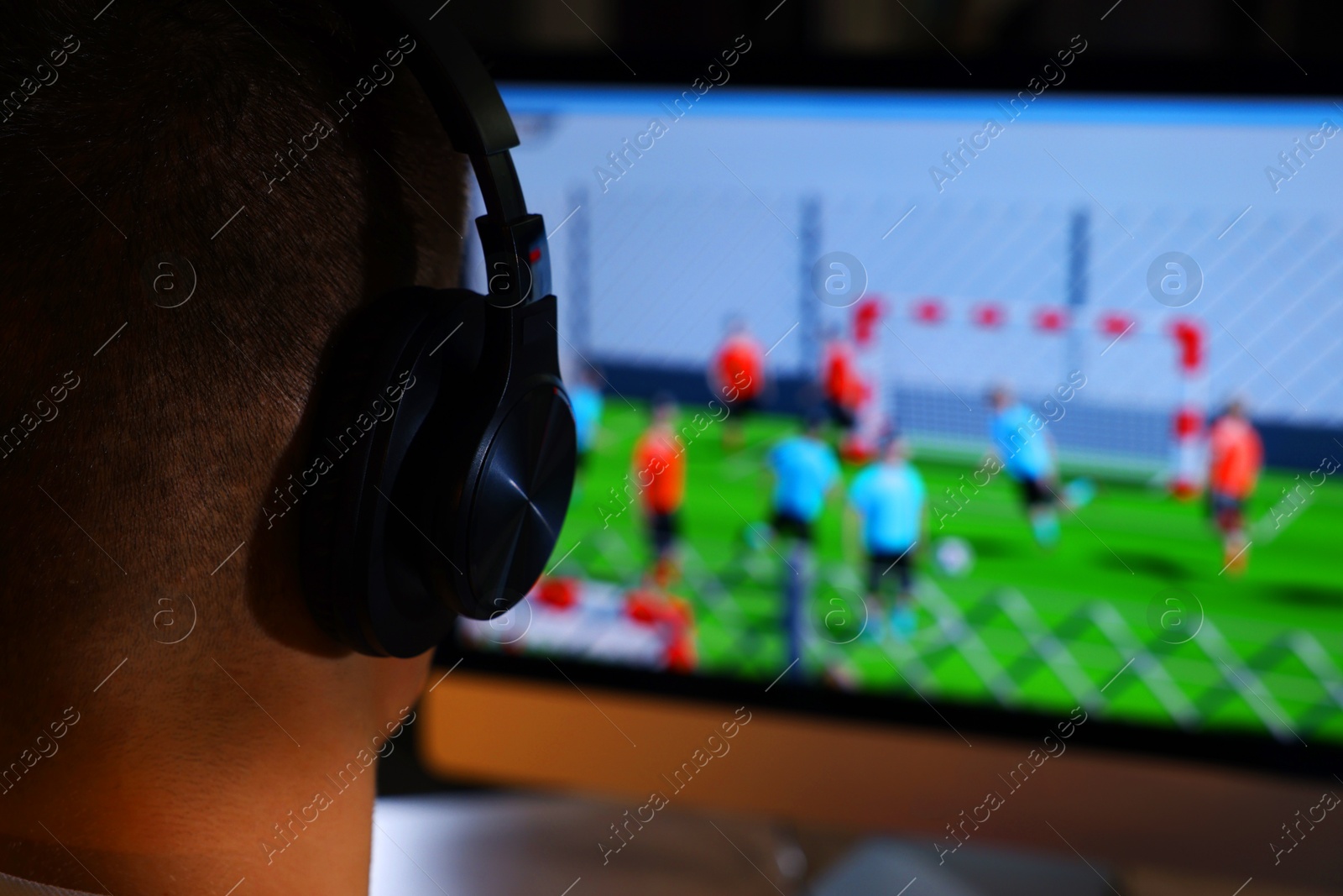 Photo of Young man playing video game at table indoors, closeup. Space for text