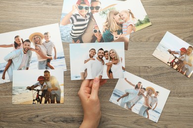 Photo of Woman with different photos at wooden table, top view