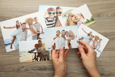 Photo of Woman with different photos at wooden table, top view