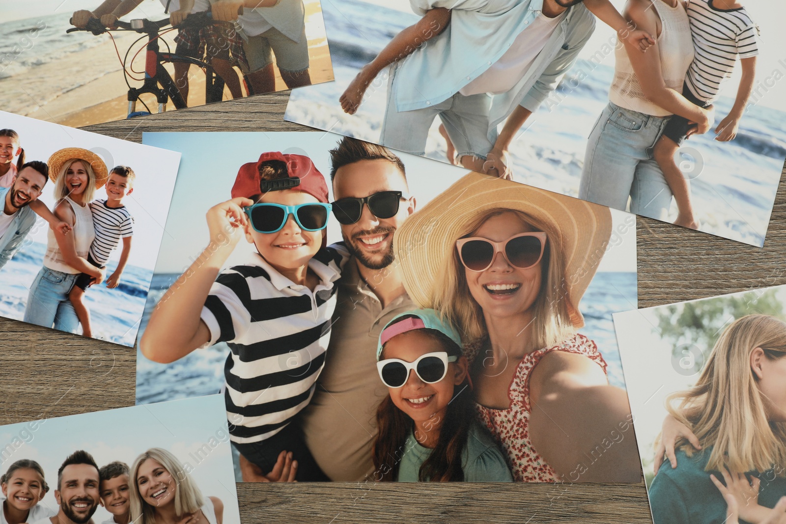 Photo of Different family photos on wooden table, flat lay