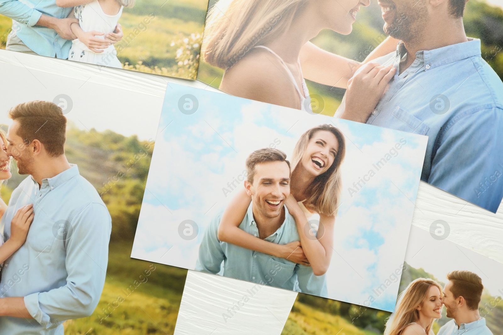 Photo of Different family photos on white wooden table, flat lay