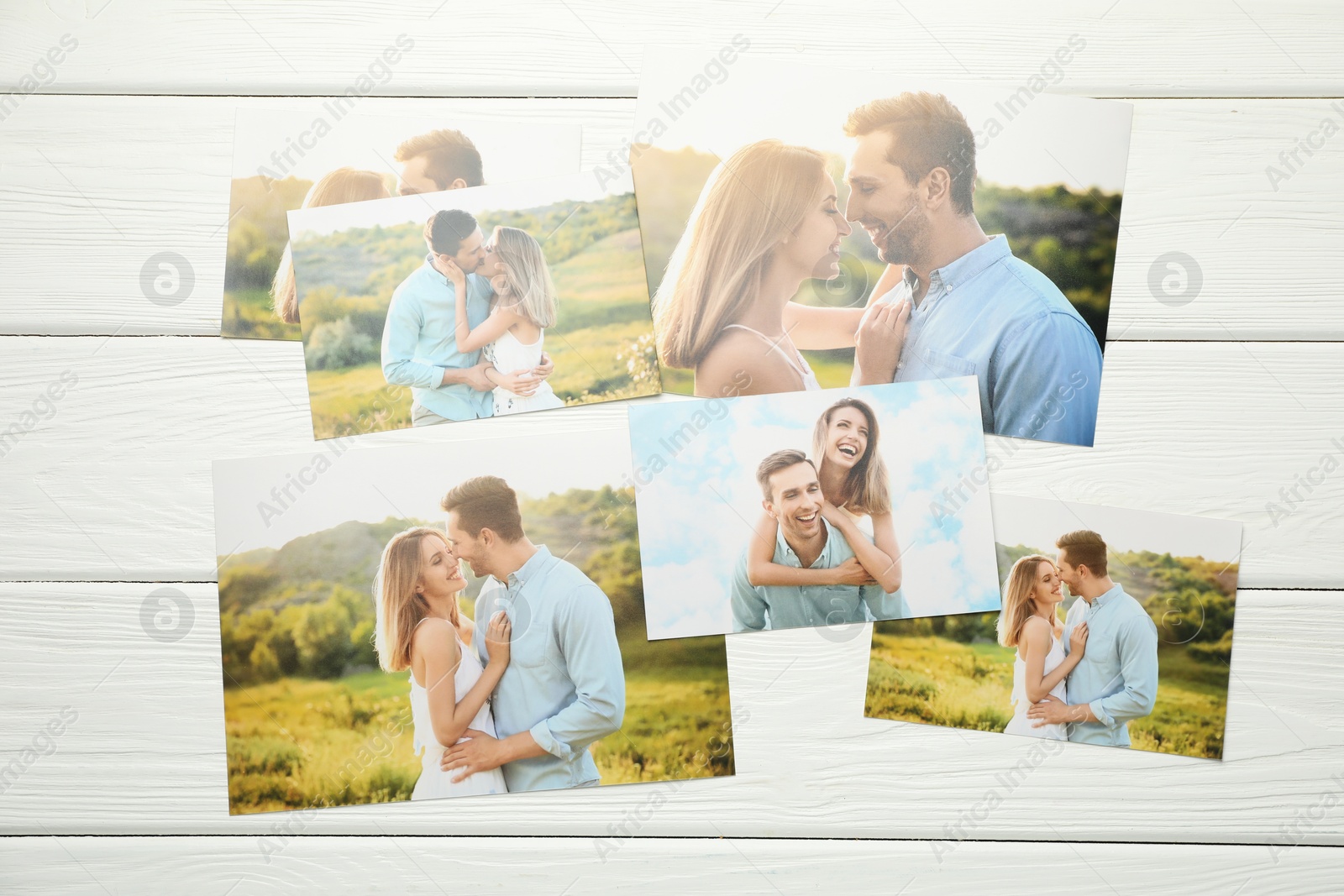 Photo of Different family photos on white wooden table, flat lay