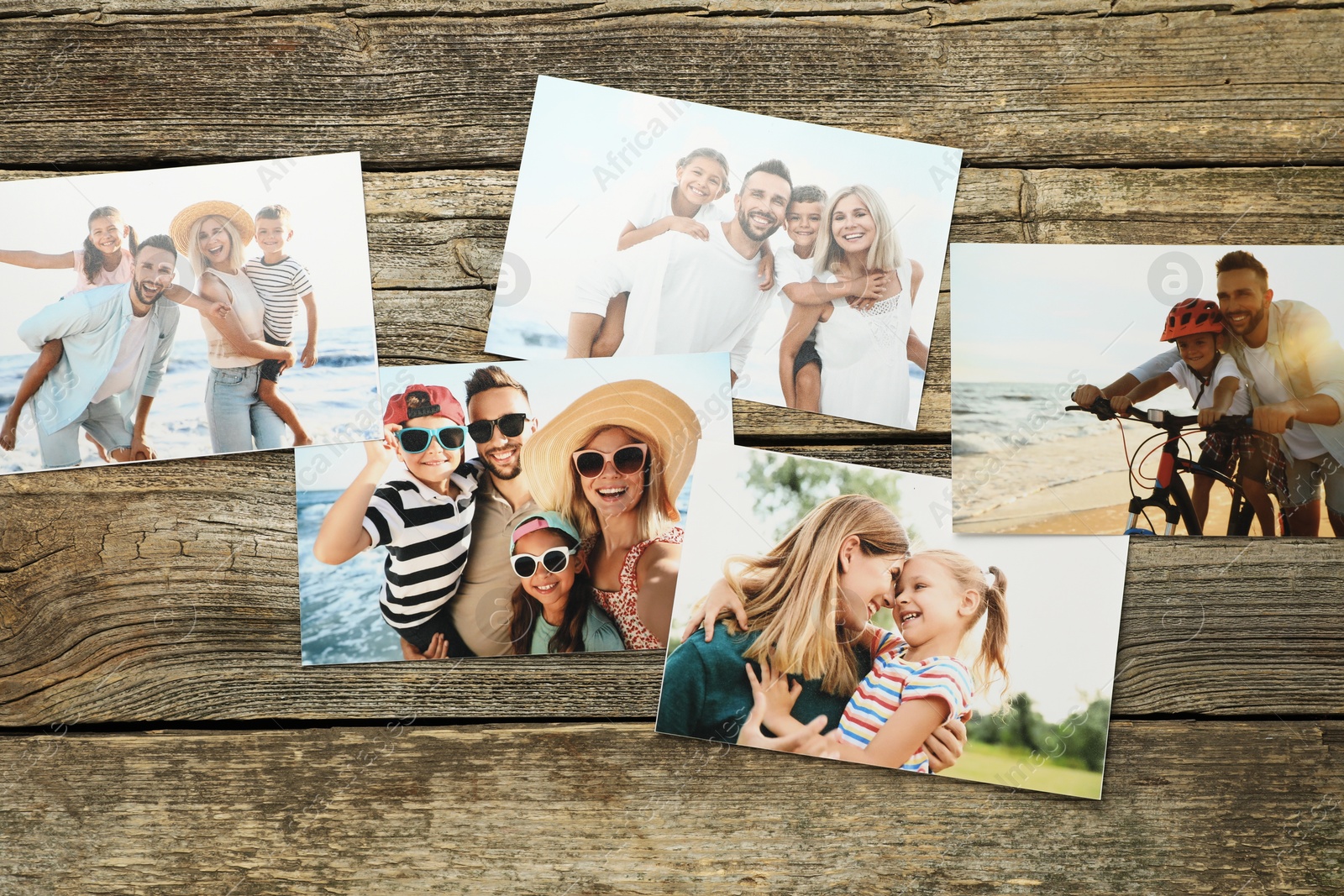 Photo of Different family photos on wooden table, flat lay