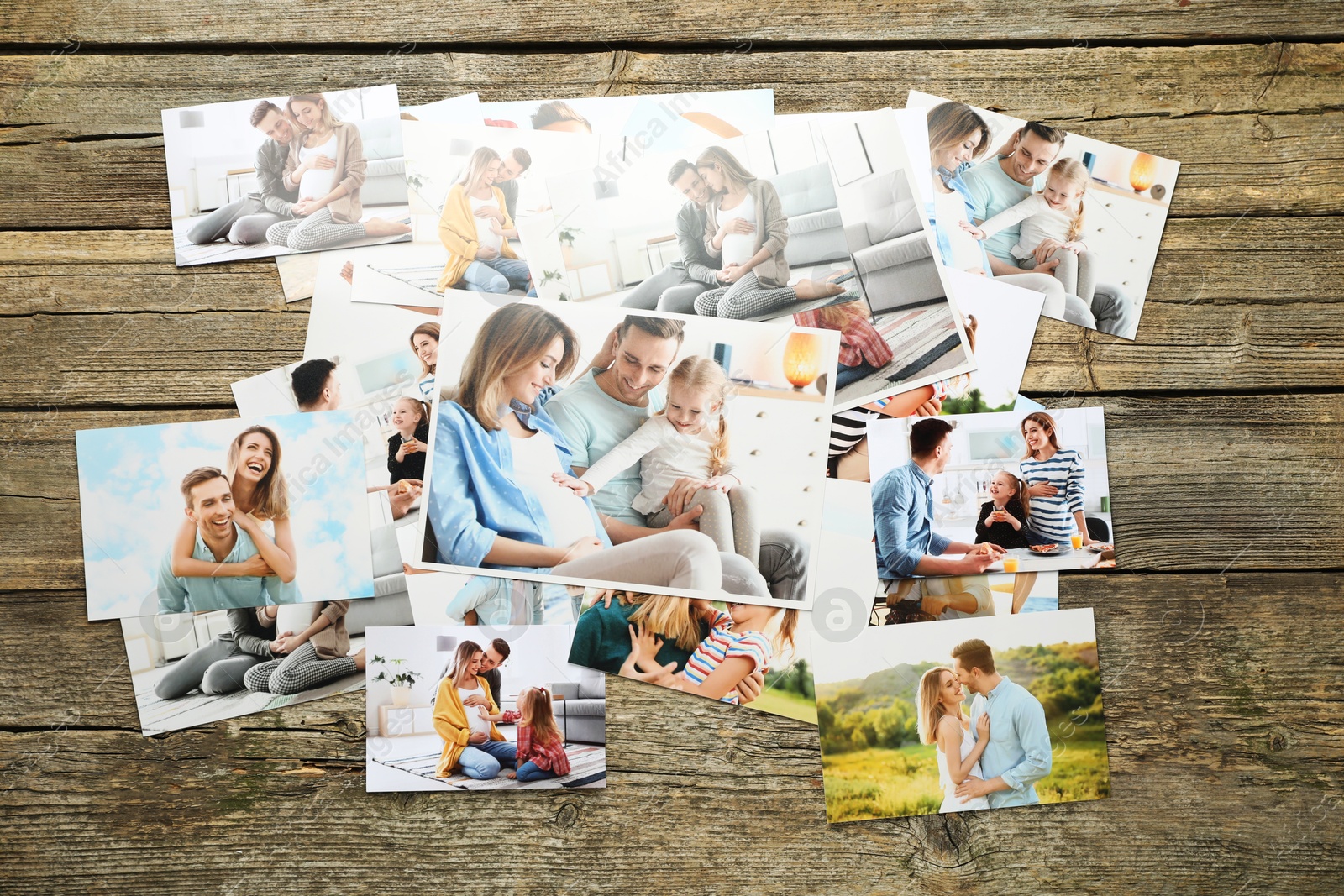 Photo of Different family photos on wooden table, flat lay