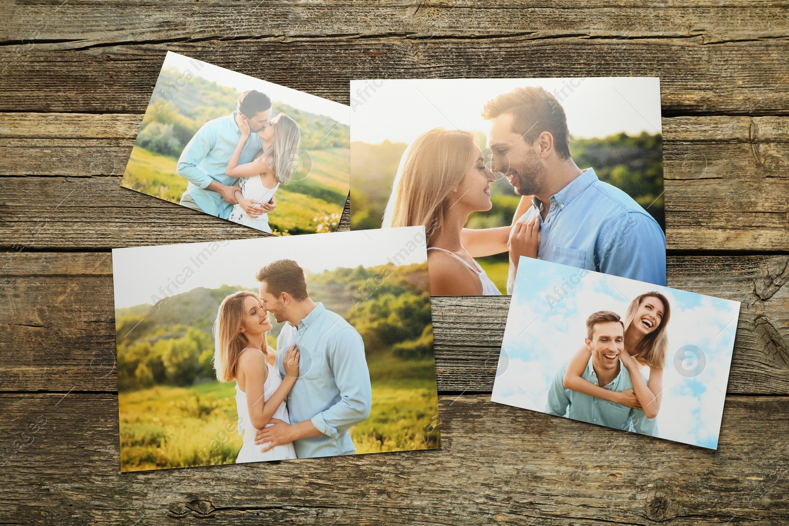 Photo of Different family photos on wooden table, flat lay