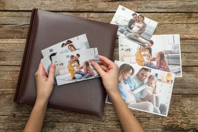 Photo of Woman with different photos and photo album at wooden table, top view